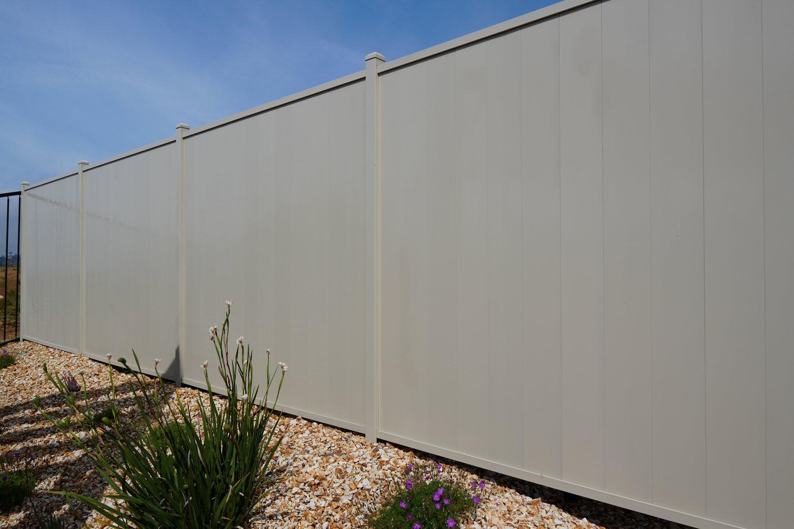 Aluma-Wall full-privacy aluminum fence run with no gaps, on gravel at the Santa Paula project